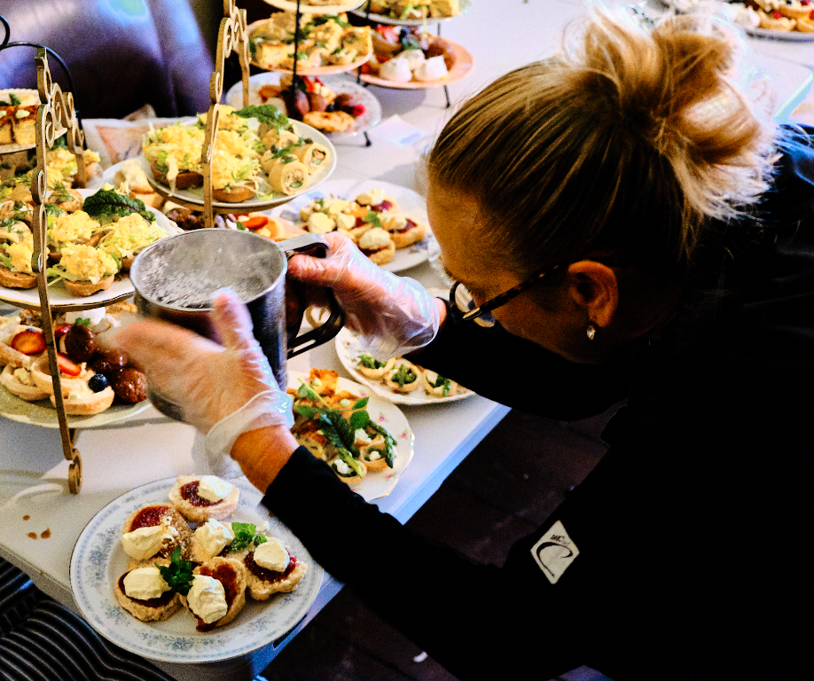 Amanda Douglass cateringdoing final touches on high tea service plates
