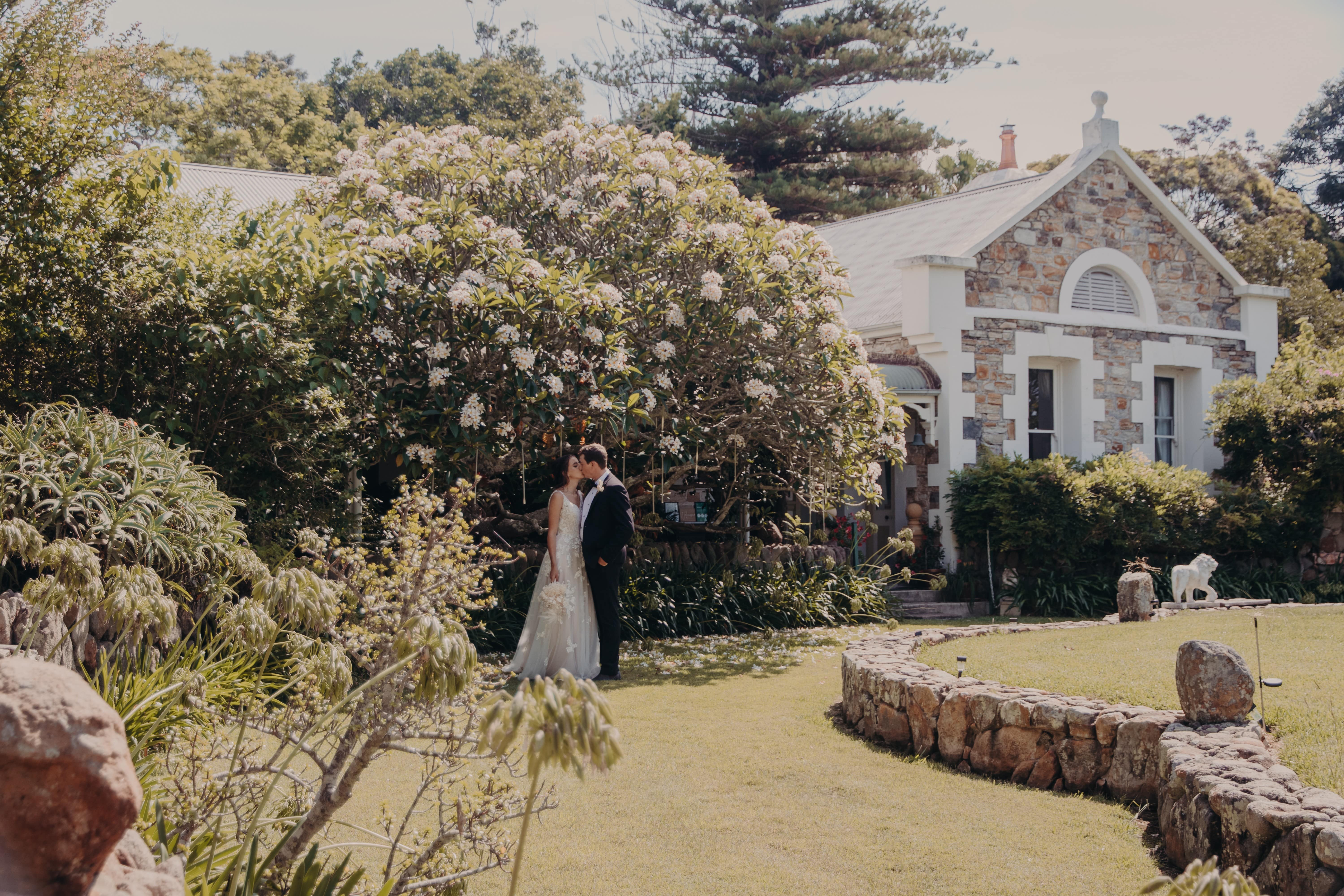 Wedding photo under frangipani tree at the front of Tanilba House