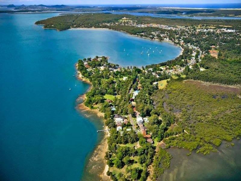 Aerial view of the peninsula which Tanilba House sits on showing the whale tail shaped land surrounded by the waters of Port Stephens
